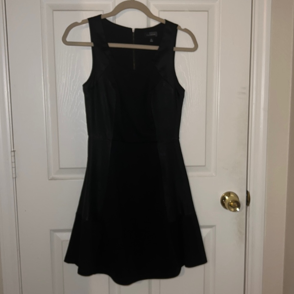 The Limited Dress with cinched waist and faux leather details.